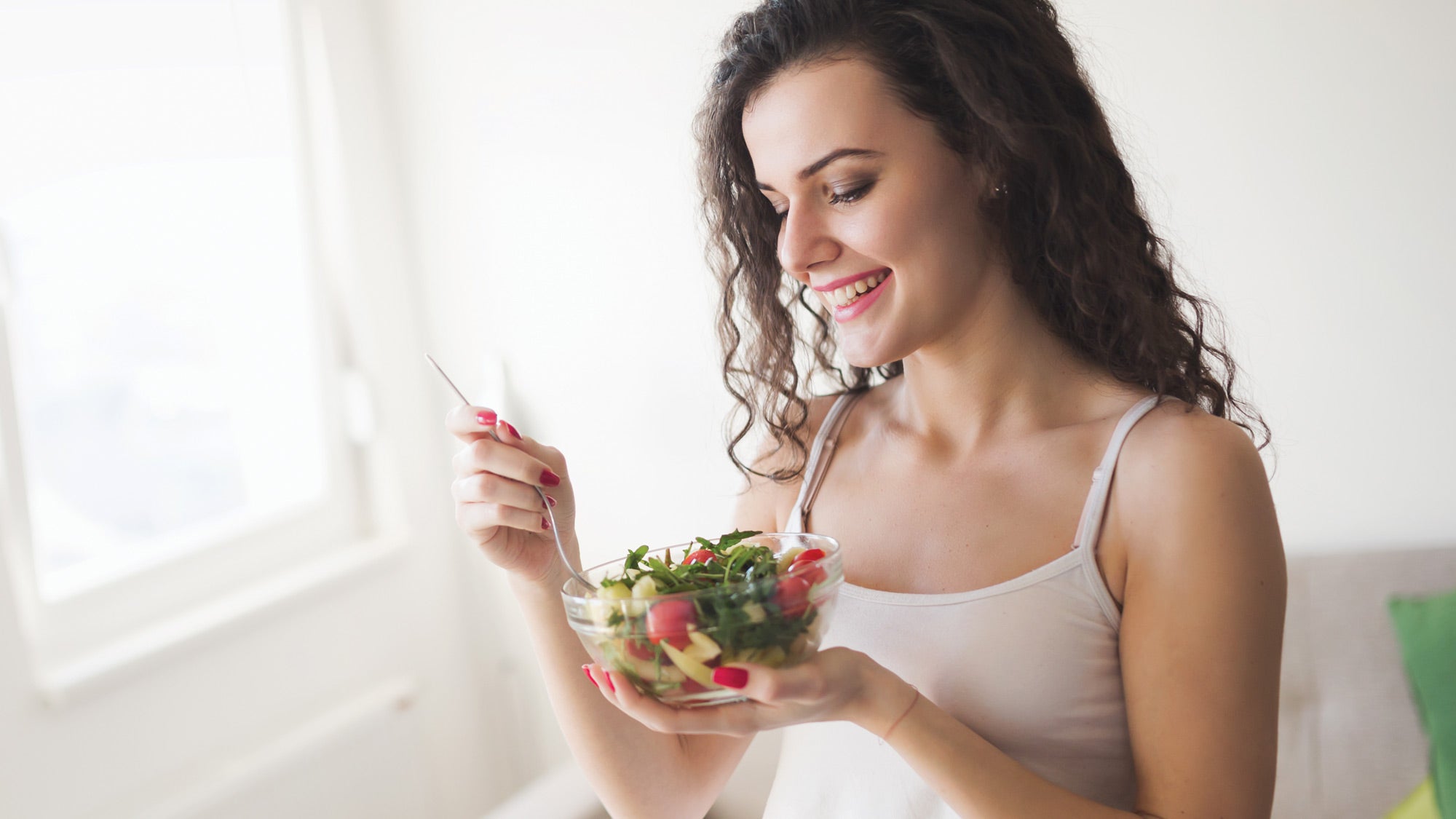 Woman eating salad
