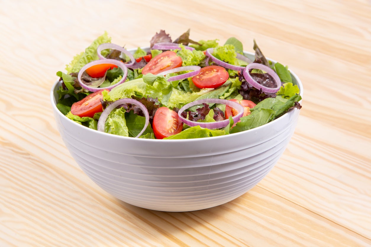 fresh vegetables salad with cabbage, onion and tomato in bowl color