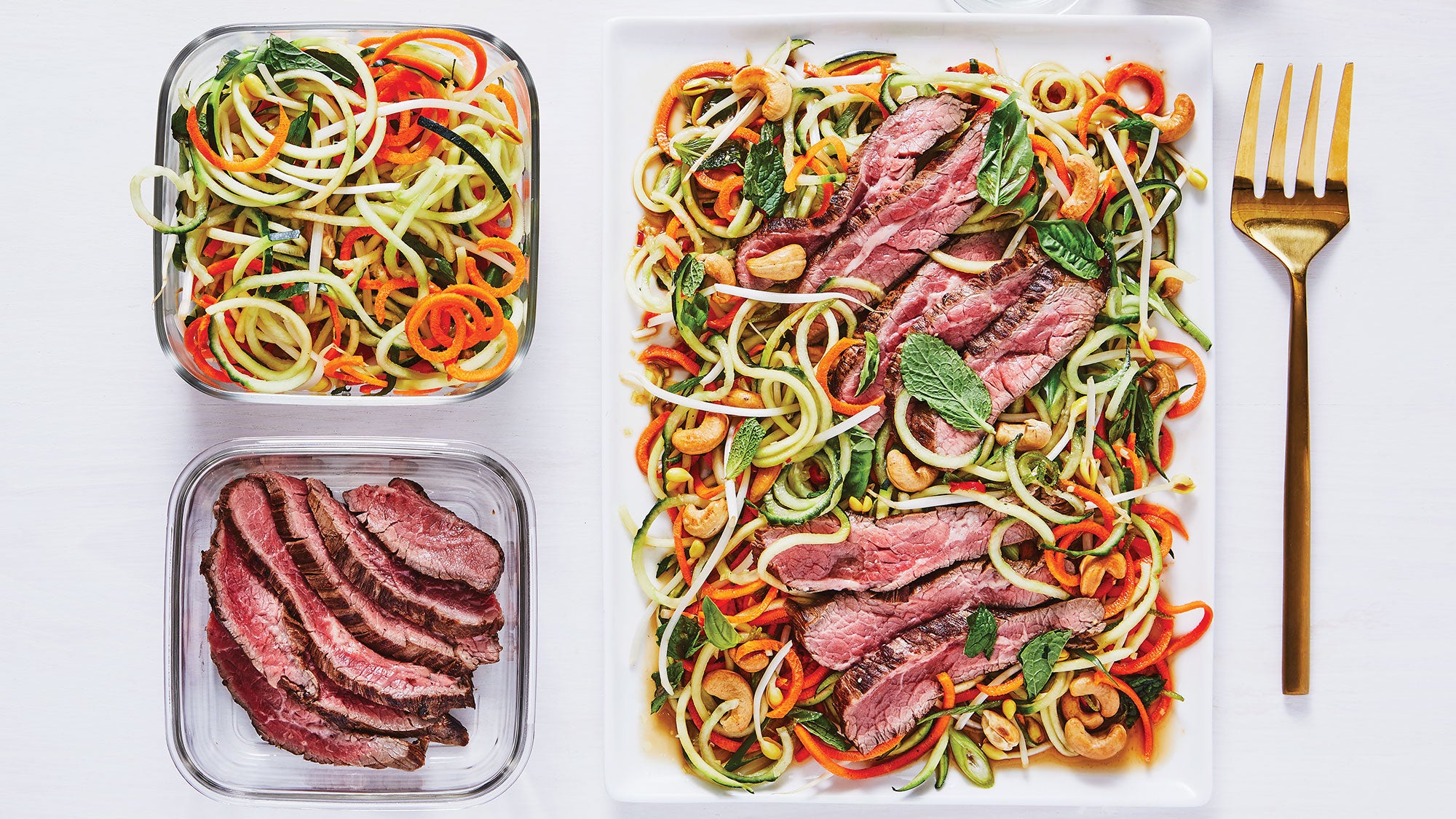 Plate of ginger steak and veggie noodles with leftovers next to it
