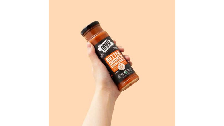 Hand holding jar of simmer sauce